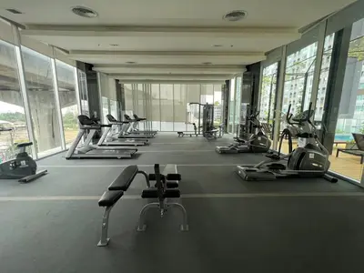 a gym with a row of treadmills and machines at Cozy8Living in Bangkok 60mto MRT in Ban Bang Khwang