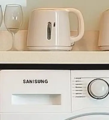 a microwave with a coffee maker on top of it at BTS Thonglor Skyline Condo in Bangkok