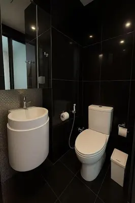 a bathroom with a white toilet and a sink at BTS Thonglor Skyline Condo in Bangkok