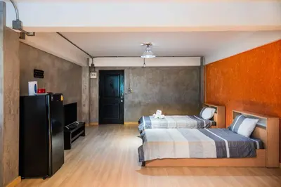a bedroom with a bed and a tv in it at Five Stars Residence in Bangkok