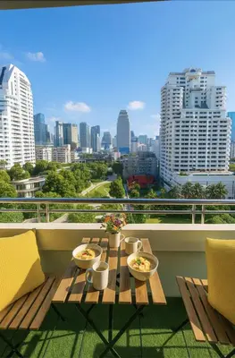 a table on a balcony with a view of a city at Great Balcony with 2 Beds Executive Unit in Bangkok