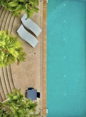 an overhead view of a swimming pool with palm trees at Great Balcony with 2 Beds Executive Unit in Bangkok