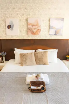 a bed with two towels and a tray on it at Great Balcony with 2 Beds Executive Unit in Bangkok