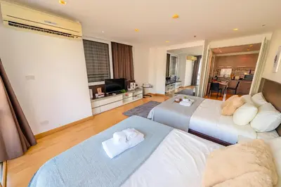a bedroom with two beds and a living room at Great Balcony with 2 Beds Executive Unit in Bangkok
