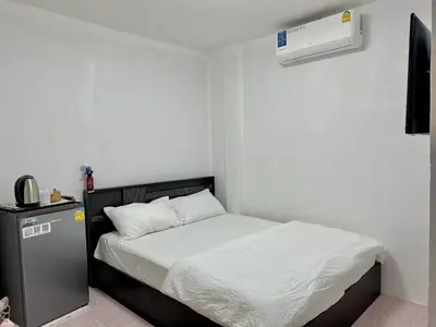 a bedroom with a bed and a air conditioner at Baan alisa 13 in Nonthaburi