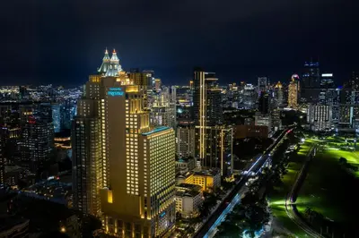 a view of a city at night at Grande Centre Point Prestige Bangkok in Bangkok