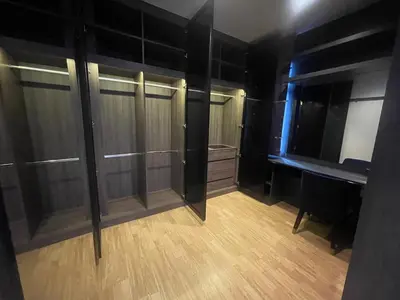 an empty closet with glass doors and a wooden floor at Maxim in Pak Kret