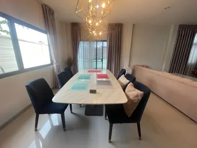 a dining room with a table and chairs at Maxim in Pak Kret