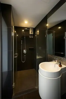 a bathroom with a glass shower and a sink at BTS Thong Lor Top Floor City View in Bangkok