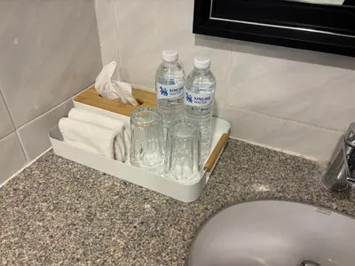 a tray with bottles of water and towels on a counter at Chic Bangkok Escape & Fast Wifi in Bangkok