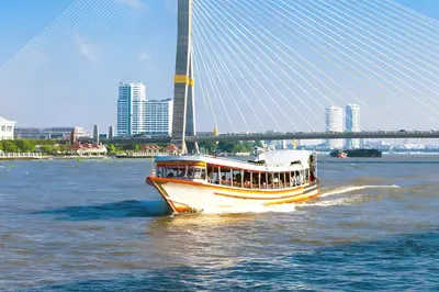 a boat on the water in front of a bridge at xx GO INN Khaosan Road Bangkok - โก อินน์ ถนนข้าวสาร in Bangkok