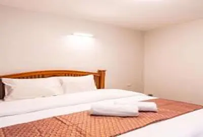 a bedroom with a bed with two towels on it at xx GO INN Khaosan Road Bangkok - โก อินน์ ถนนข้าวสาร in Bangkok