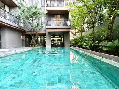 a swimming pool in the middle of a building at Klass Langsuan Condo in Bangkok