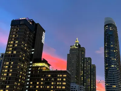 a group of tall buildings in a city at sunset at Klass Langsuan Condo in Bangkok