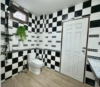 a bathroom with black and white checkered walls and a toilet at 8Pax Spacious Private Home near The Mall Bangkapi in Ban Bang Toei (1)