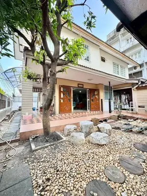 a tree in front of a building with rocks at 8Pax Spacious Private Home near The Mall Bangkapi in Ban Bang Toei (1)