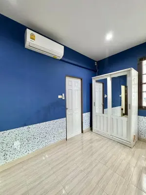 a room with a blue wall with a air conditioner at 8Pax Spacious Private Home near The Mall Bangkapi in Ban Bang Toei (1)