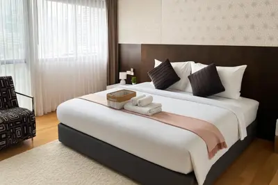 a bedroom with a large bed with a box on it at Cozy stylish home near Nana BTS in Bangkok