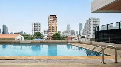a large swimming pool on the roof of a building at Cozy stylish home near Nana BTS in Bangkok