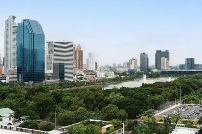 a city skyline with a river and buildings at Cozy stylish home near Nana BTS in Bangkok