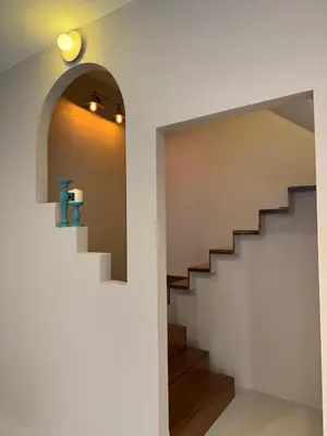 a staircase in a house with a blue vase at Ranana Bangkok in Bangkok