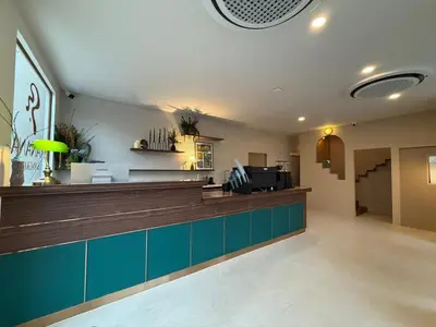 a lobby with a counter with blue cabinets at Ranana Bangkok in Bangkok