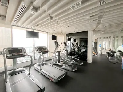 a gym with treadmills and ellipticals in a building at River View Modern 1BR - Weekly Cleaning - Phrom Phong in Bangkok