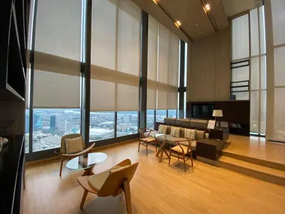 a living room with a couch and tables and chairs at River View Modern 1BR - Weekly Cleaning - Phrom Phong in Bangkok