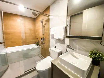 a bathroom with a toilet and a sink and a shower at Modern-Design Apt 45 sqm - Ultra Fast WiFi - Ekamai in Bangkok