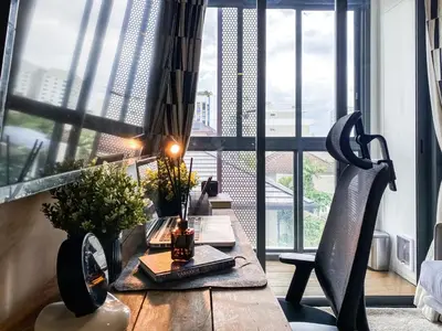 a dining table in a room with a large window at Modern-Design Apt 45 sqm - Ultra Fast WiFi - Ekamai in Bangkok