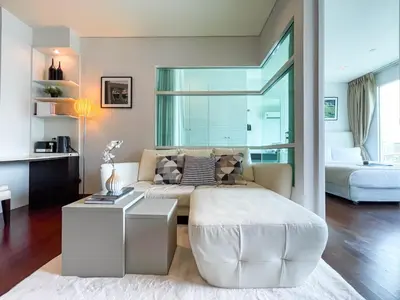a living room with a couch and a bed at Near BTS Thong Lor l Workspace and Kitchen l Sontana in Bangkok