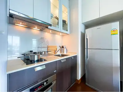 a kitchen with a stainless steel refrigerator and a sink at Near BTS Thong Lor l Workspace and Kitchen l Sontana in Bangkok