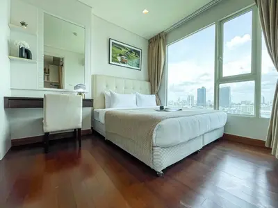 a hotel room with a bed and a desk and window at Near BTS Thong Lor l Workspace and Kitchen l Sontana in Bangkok