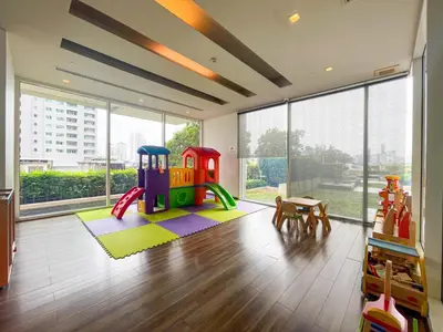 a living room with a play room with a play set at Near BTS Thong Lor l Workspace and Kitchen l Sontana in Bangkok