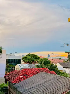 a roof with red flowers on top of a city at Lazy Sunday Khaosan Hotel in Bangkok