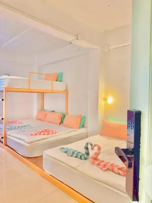 two bunk beds in a room with a tv at Lazy Sunday Khaosan Hotel in Bangkok