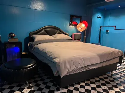a bedroom with a large bed with a blue wall at The oasis on 8 Villa pool table & KTV in Bangkok