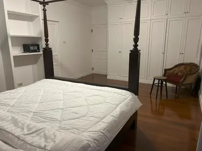 a bedroom with a large bed with a white bedspread at The oasis on 8 Villa pool table & KTV in Bangkok