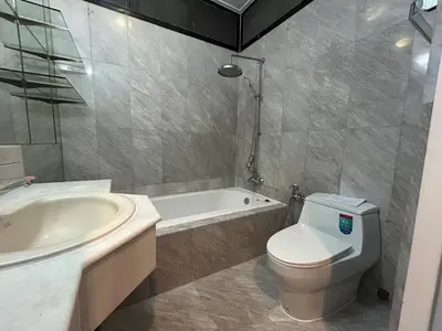 a bathroom with a toilet and a tub and a sink at The oasis on 8 Villa pool table & KTV in Bangkok