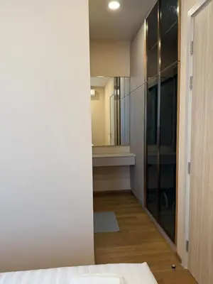 a bedroom with a closet and a mirror at Luxury 1 bedroom near Siam Paragon in Bangkok