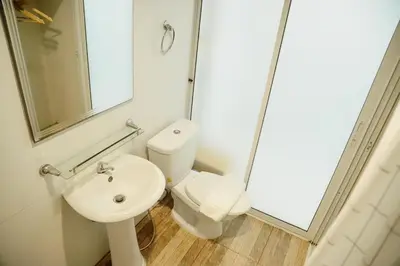 a bathroom with a toilet and a sink at Full Stop Pool Villa Don Mueang in Lak Si