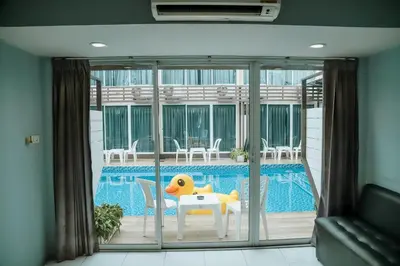 a house with a pool and a table with a yellow duck on it at Full Stop Pool Villa Don Mueang in Lak Si