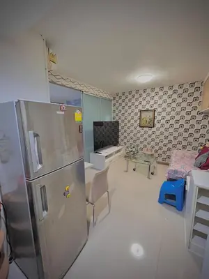 a kitchen with a refrigerator and a living room at Stylish Bangkok Condo Furnished, Pool View Prime Location in Bangkok