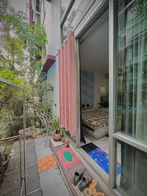 a room with a sliding glass door and a bedroom at Stylish Bangkok Condo Furnished, Pool View Prime Location in Bangkok