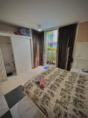 a bedroom with a bed with a rug on it at Stylish Bangkok Condo Furnished, Pool View Prime Location in Bangkok
