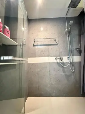 a bathroom with a shower with a glass door at BTS Thong Lor Downtown Low-rise Large 1 Bedroom in Bangkok