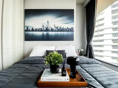 a bedroom with a bed with a picture of a city at Upscale High-Rise 1BR - Ultra Fast Wifi - Phrom Phong in Bangkok