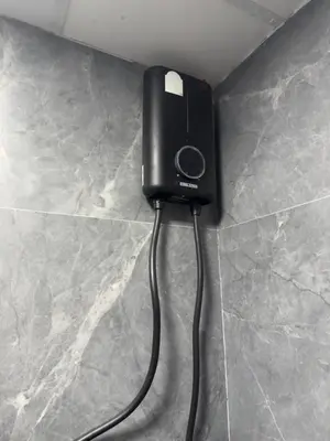 a black phone is plugged into a wall at Kinboshi Hostel Silom in Bangkok