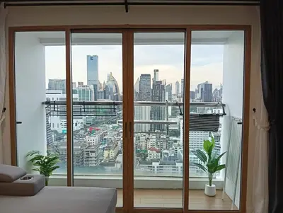 a bedroom with a large window with a view of a city at Modern 59m Sukhumvit 1BR - 31st Floor Pool - Gym in Makkasan