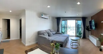 a living room with a couch and a table at Modern 59m Sukhumvit 1BR - 31st Floor Pool - Gym in Makkasan